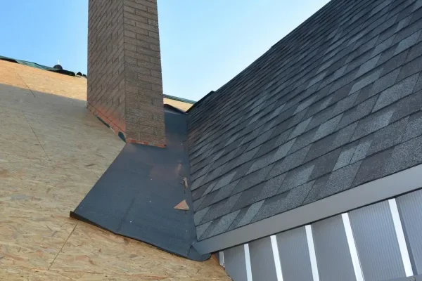 Reroof-SRC-Roofing-Construction-with-Asphalt-Shingles-corner-waterproofing.-Close-up-on-laying-asphalt-shingles-in-the-house-attic-rooftop-corner-problem-area-1-scaled-v3