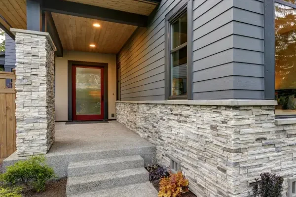 Siding-SRC-Luxurious-new-home-with-curb-appeal.-Trendy-grey-two-story-exterior-in-Bellevue-with-large-picture-windows-stone-siding-covered-porch-and-concrete-pathway.-Northwest-2-scaled-v3